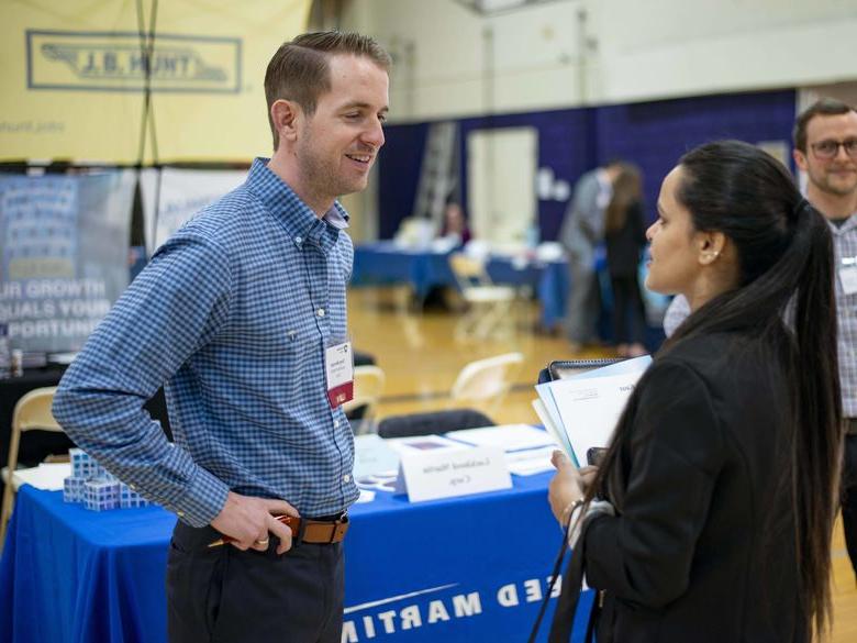 Student at the career fair talking with employer 